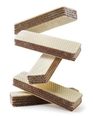 Wafers biscuits are falling on a pile close-up on a white background. isolated clipart
