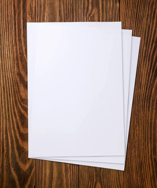 stock image A4 paper sheets on a wooden background. Top view