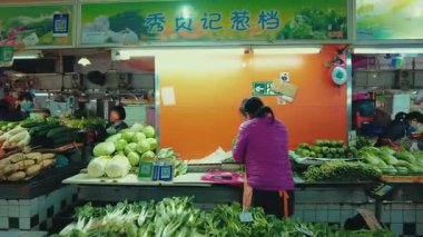 GuANGZHOU, ÇİN 2, 2021: Mağazaları ve yayaları olan şehir sokak manzarası