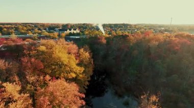 Gün doğumunda güzel bir sonbahar yeşilliği olan bir kasabanın yerleşim bölgesi manzarası.