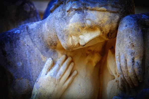 Fragment of an ancient stone statue of sad and desperate woman on tomb as a symbol of death and the end of human life. Horizontal image.