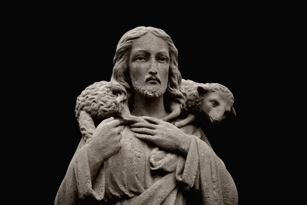 Ancient statue of Jesus Christ is the Good Shepherd with the lost sheep on his shoulders.