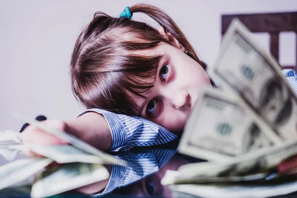 Business finance, banking and money concept. Portrait of young pretty girl with lot of money. Horizontal image.