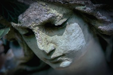 Close up beautiful tender look of a sad angel looking down.