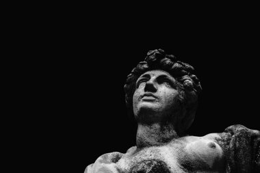 Close up fragment of an ancient statue of Olympic goddess of love in antique mythology Aphrodite (Venus). Copy space.