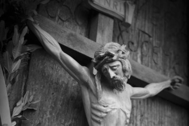 Holy cross with crucified Jesus Christ. Ancient wooden statue. 