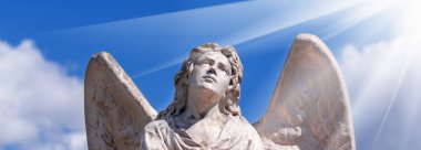 Angel. Fragment of ancient stone statue. Horizontal image.