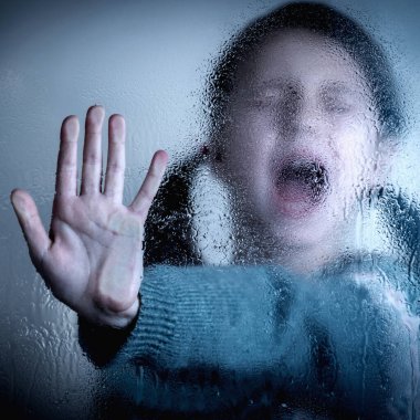 Portrait of young child girl showing STOP gesture