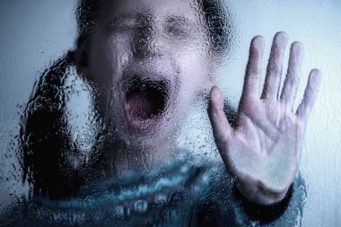 Dramatic portrait of brunette young girl doing stop singing with palm of the hand. Warning gesture.