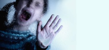 Dramatic portrait of brunette young girl doing stop singing with palm of the hand. Warning gesture. Copy space.