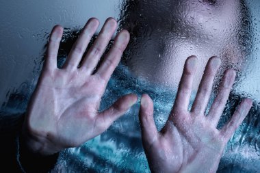 Dramatic portrait of young child girl showing STOP gesture