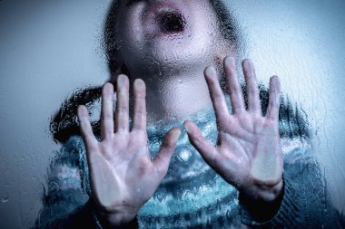 Young kid saying NO and showing STOP with palm of the hand. Warning gesture.