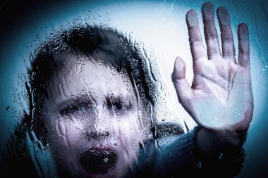 Young child girl says NO to bullying with hand stop gesture