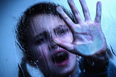 Stop violence against children and child abuse problem. Human Rights Day concept. Scared little caucasian girl showing a stop sign with her hand. Horizontal image.