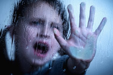 Portrait of young girl with her hand extended showing STOP gesture. Protest against domestic violence, against discrimination or school abuse. Copy space.