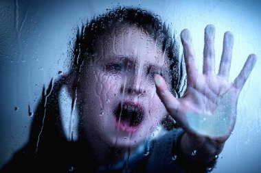 Girl with her hand extended showing STOP gesture. Protest against domestic violence, against discrimination or school abuse.