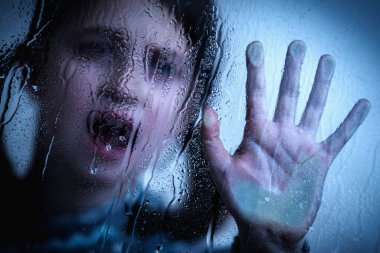 Children violence. Young girl with her hand extended showing STOP gesture. Horizontal image. Selective focus.