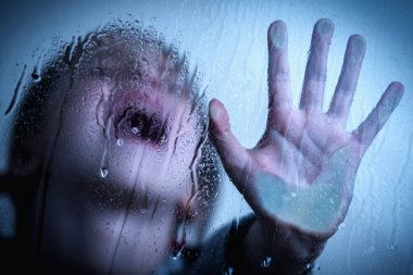 Young girl showing STOP gesture with her hand. Concept of domestic violence and child abuse.  Protest against domestic violence, against discrimination or school abuse.