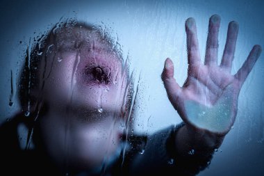 Portrait of young girl showing STOP gesture with her hand. Concept of domestic violence and child abuse. Horizontal image.
