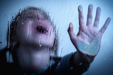 Young girl showing STOP gesture with her hand. Concept of domestic violence and child abuse.