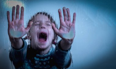 Portrait of up upset little girl protesting behind wet glass. Copy space for text or design. 