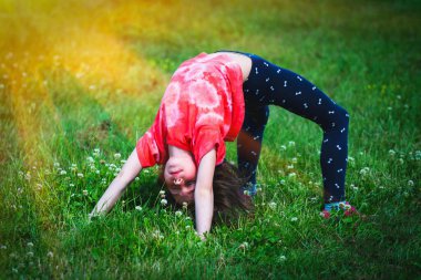 Yoga classes outside on the open air. Kids Yoga concept. Horizontal image. 