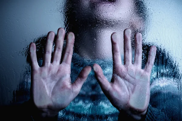 Serious and determined young girl, putting hand in front and showing STOP gesture. 