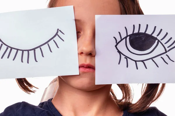 Close up conceptual portrait of young girl with painted closed and open eyes as symbol of double standards and selective justice.