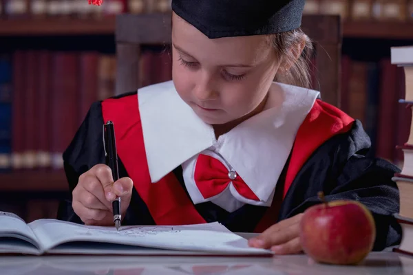 Education, school, knowledge and people concept. Happy beautiful child girl  in graduation cap learning in library. Horizontal image.