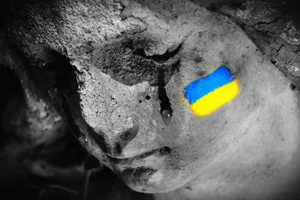 Close up crying angel with facial Ukrainian flag makeup as symbol of pray for Ukraine and Ukraine peace. Save Ukraine from russia.