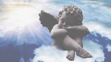 Gökyüzündeki bulutlarda bir melek uyuyor. Antik bir heykelin parçası. Yatay resim.