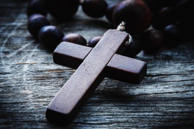 Macro image of rosary cross and beads as a symbol of salvation and eternal life. 