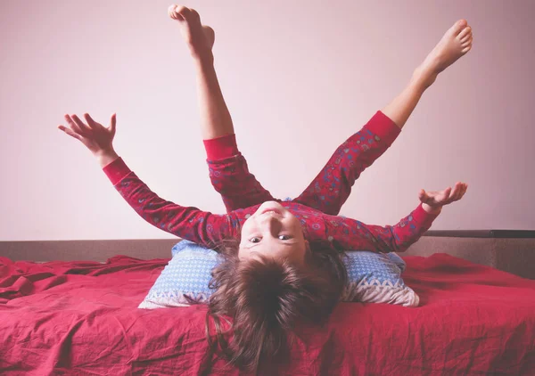 stock image I do not want to sleep yet. Funny portrait of cute active little girl having fun and doesn't want going to fall asleep. (Happy childhood, rest, dream, kids concept). Horizontal image.