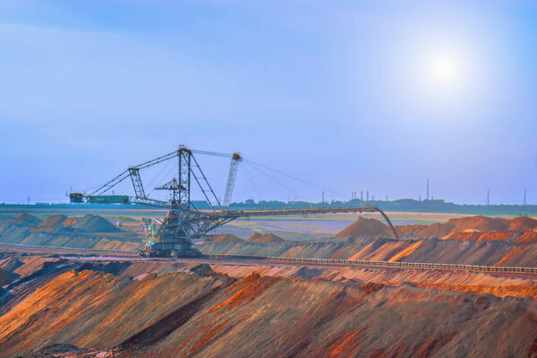 Industrial view of opencast mining quarry with machinery at work. Area has been mined for copper,silver, gold, and other minerals