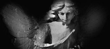 Güneş ışığındaki meleğin siyah beyaz görüntüsü. Antik heykel