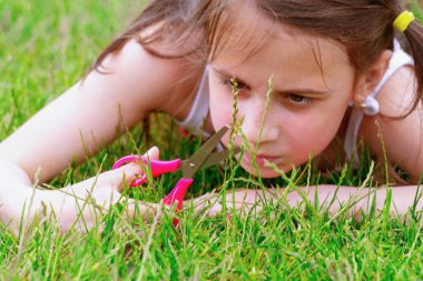 Kavramsal görüntü: Obsesif-kompulsif bozukluk (OCD), Genç kız çimleri biçiyor ve mükemmel bir şekilde eşitlemeye çalışıyor. Gözlere odaklan. Yatay resim.