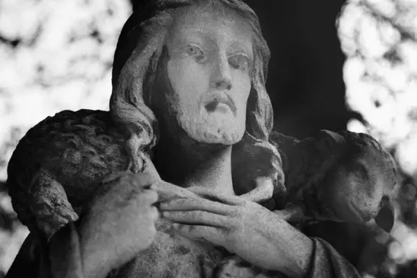 image of antique statue Jesus Christ Good Shepherd (fragment of ancient sculpture, close up). Black and white image.