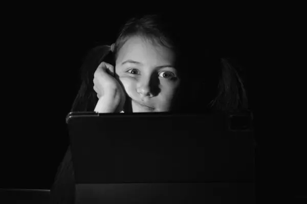 Lack of sleep as a result of studying at night may impair children\'s mood, increase stress and anxiety levels and decreased cognitive abilities. Young stressed girl studies at night.