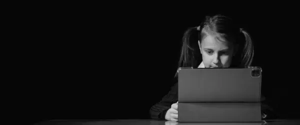 Computer, media, game, network, digital, technology, gadget  and  internet addiction. Young happy beautiful girl using computer night Copy space for text or design. Black and white horizontal image.
