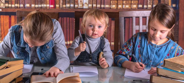 Child development and early learning. Funny portrait of little scientists studying and read books in the library. Humorous photo. Horizontal image.
