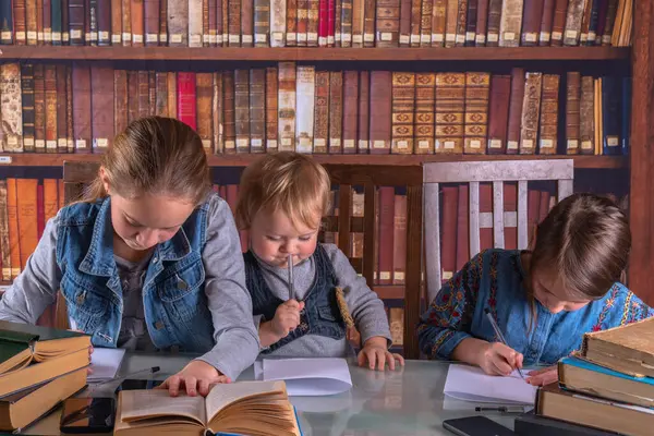 Conceptual image: child development and early learning. Funny portrait of little scientists studying and read books in the library. Humorous photo. Horizontal image.