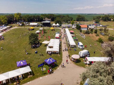 5 Haziran 2022 'de. - TEMERIN, SERBIA: Sırbistan 'ın Temerin kentinde 5 Haziran 2022' de Sırbistan 'da düzenlenen Pasuljijada Bean Festivali 2022 Gıda ve Müzik Festivali Sahneleri. İnsanlar güzel bir yaz gününün tadını çıkarırken, geleneksel yemek ve içecekler DJ ve müzik B