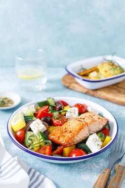 Greek salad with grilled salmon fish. Traditional mediterranean cuisine. Healthy food, diet