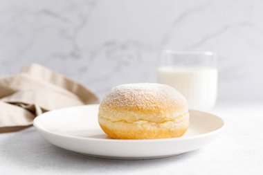 Berliner donut. Traditional german donut with raspberry jam, dusted with icing sugar
