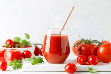 Tomato juice in a glass and fresh tomatoes