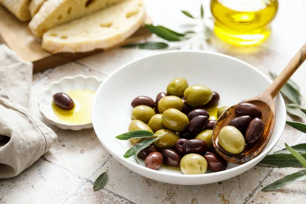 Olives, ciabatta and olive oil in a bottle