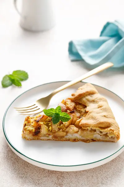 Apple pie slice with cinnamon and lemon zest on a plate