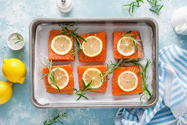 Salmon. Fresh raw salmon fish fillet with cooking ingredients, rosemary and lemon, top view