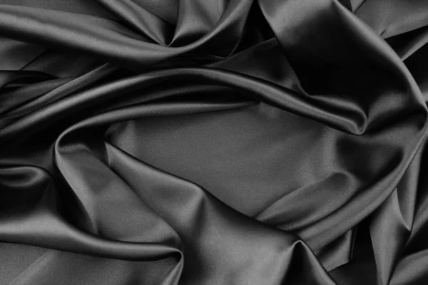 Zbliżenie Falistej Czarnej Tkaniny Jedwabnej — Zdjęcie stockowe