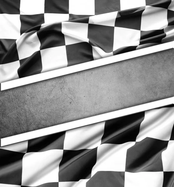 Checkered black and white flag on grey background. Copy space